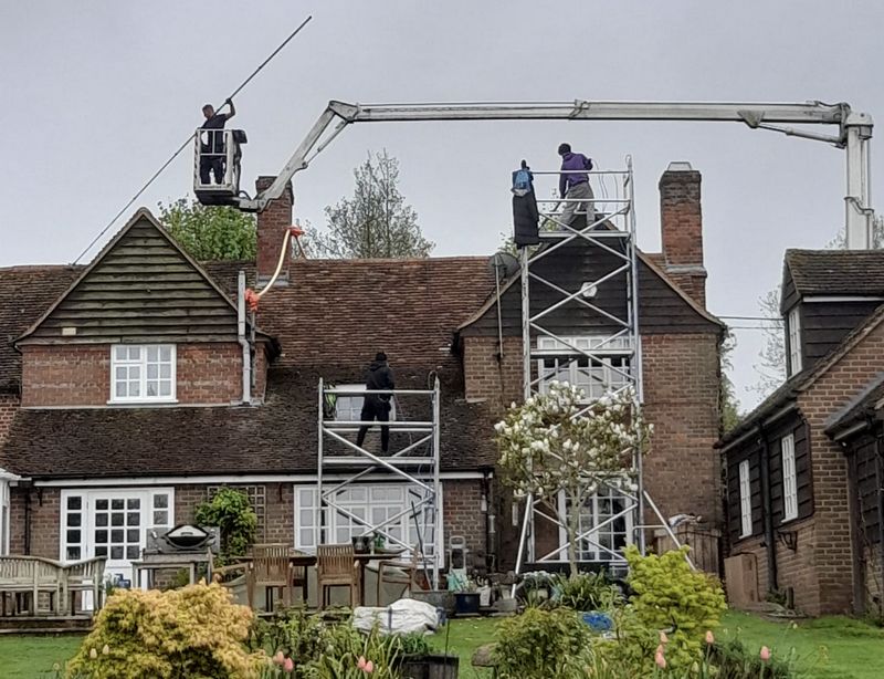 The Moss Cleaners using cherry picker and scaffolding to clean roof safely and professionally in 101 Ridgway, London SW19 4SX, UK, 101 Ridgway, London SW19 4SX, UK
